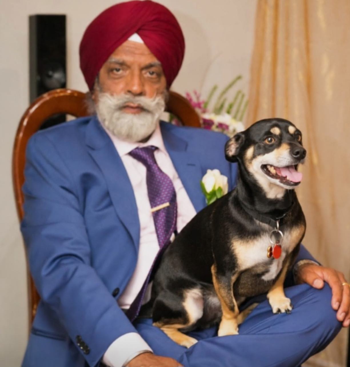Gurbinder Singh Jaspal seated with his dog